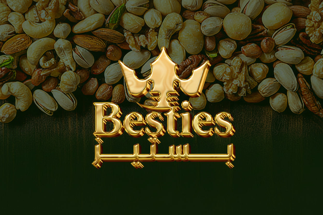 Gold 'Besties' logo with a crown design on a background of various nuts and seeds.